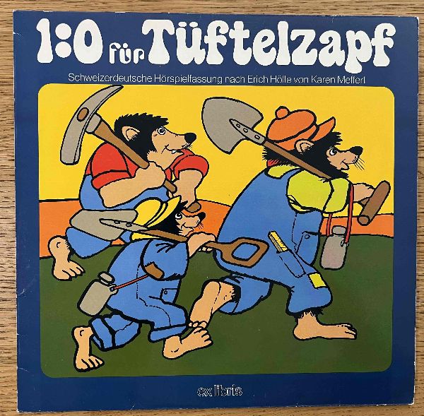 1:0 FÜR TÜFTELZAPF originale LP in Mundart mit Karen Meffert Originale Schallplatte zeigt auf Seite # 2 einen oberflächlchen Wischer, der aber nicht hörbar ist. Ansonsten aber in schönem Zustand.